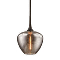 "close-up of teardrop-shaped seeded glass pendant with warm glowing bulb"